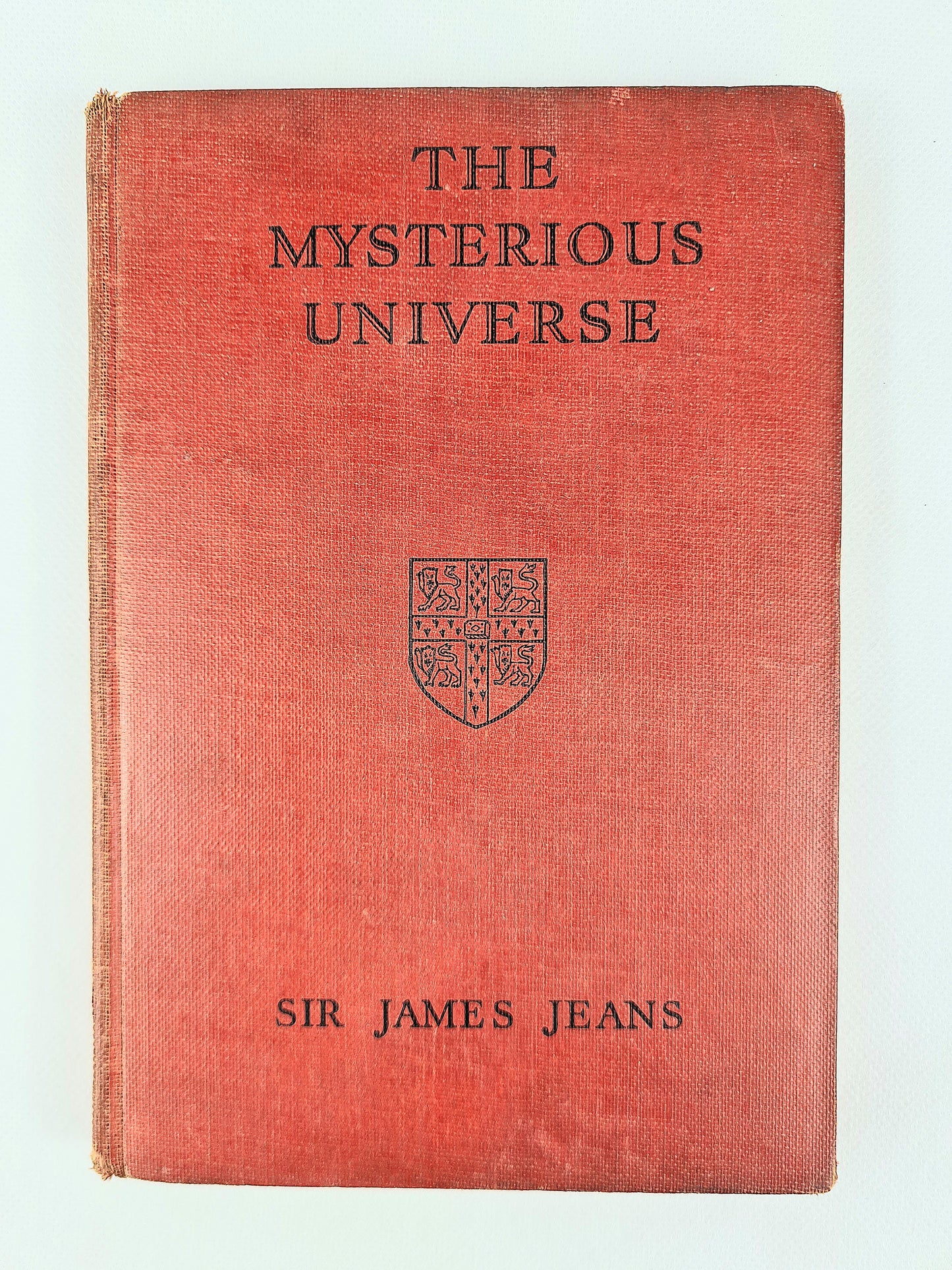 Red Hardback antique science book. The Mysterious Universe