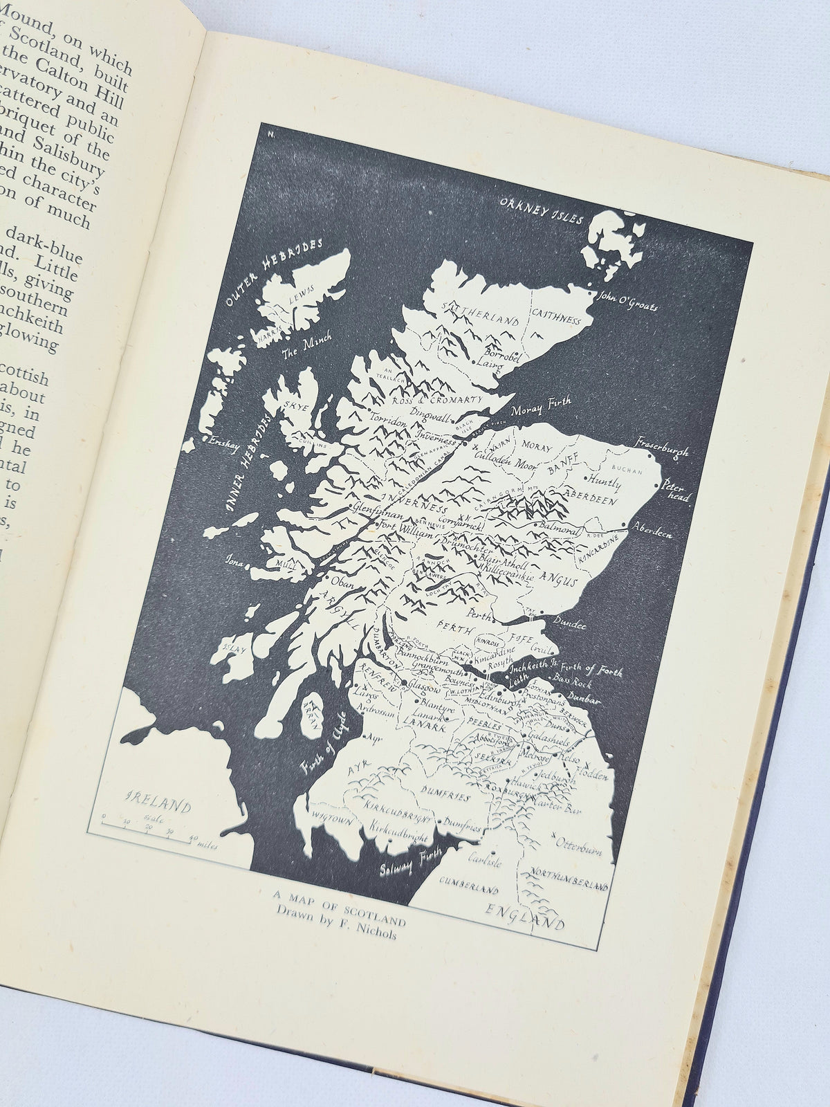 Front cover of The Story of Scotland by F. Fraser Darling, 1942 Britain in Pictures edition, with blue thistle design and visible light wear.