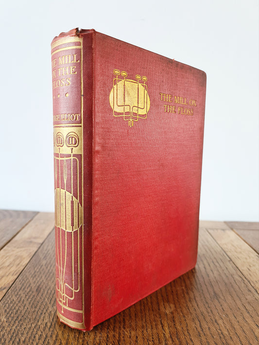 Antique edition of The Mill On The Floss by George Eliot. Red and gold cover design 