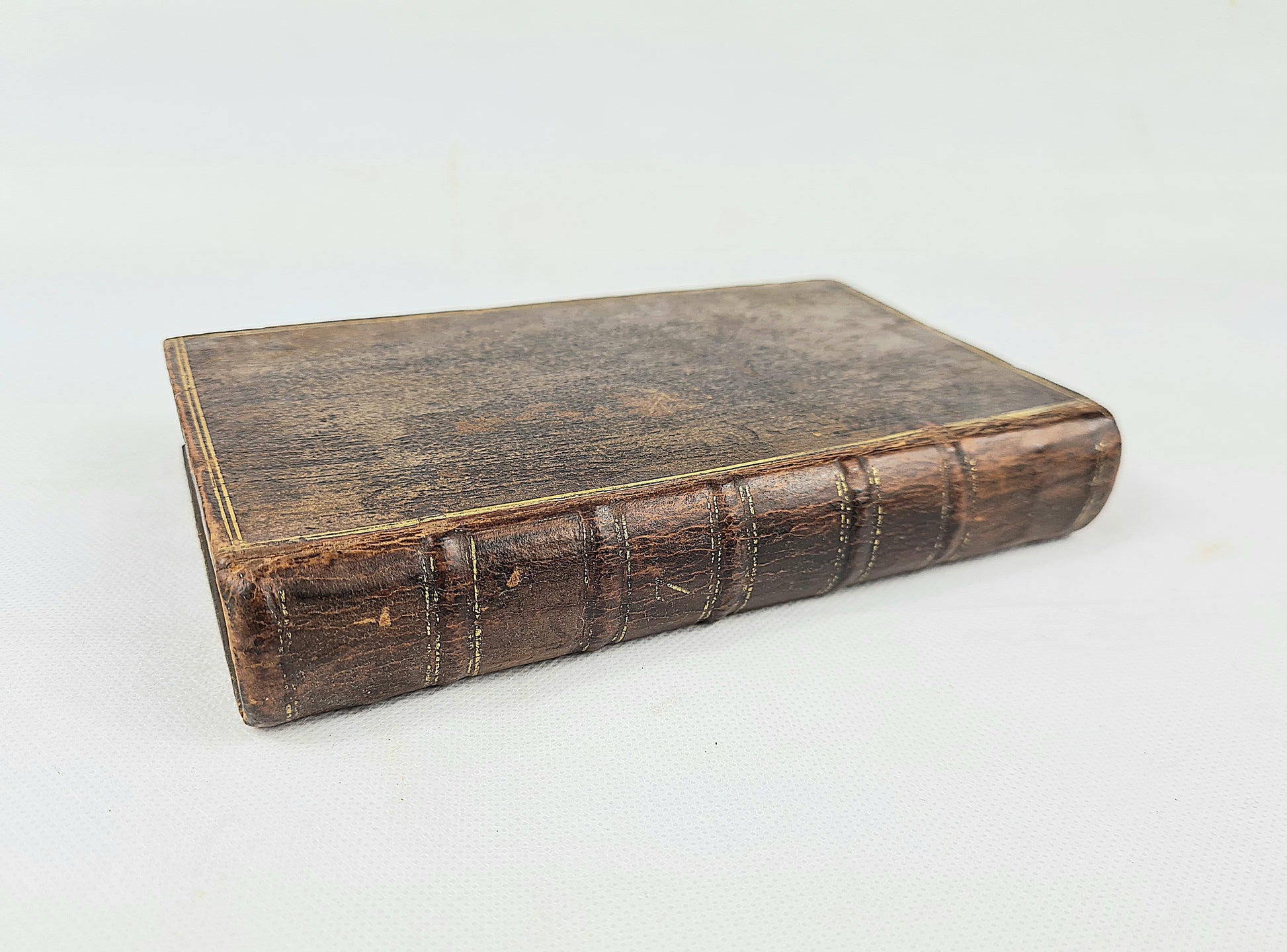 Antique leather-bound book on a white background