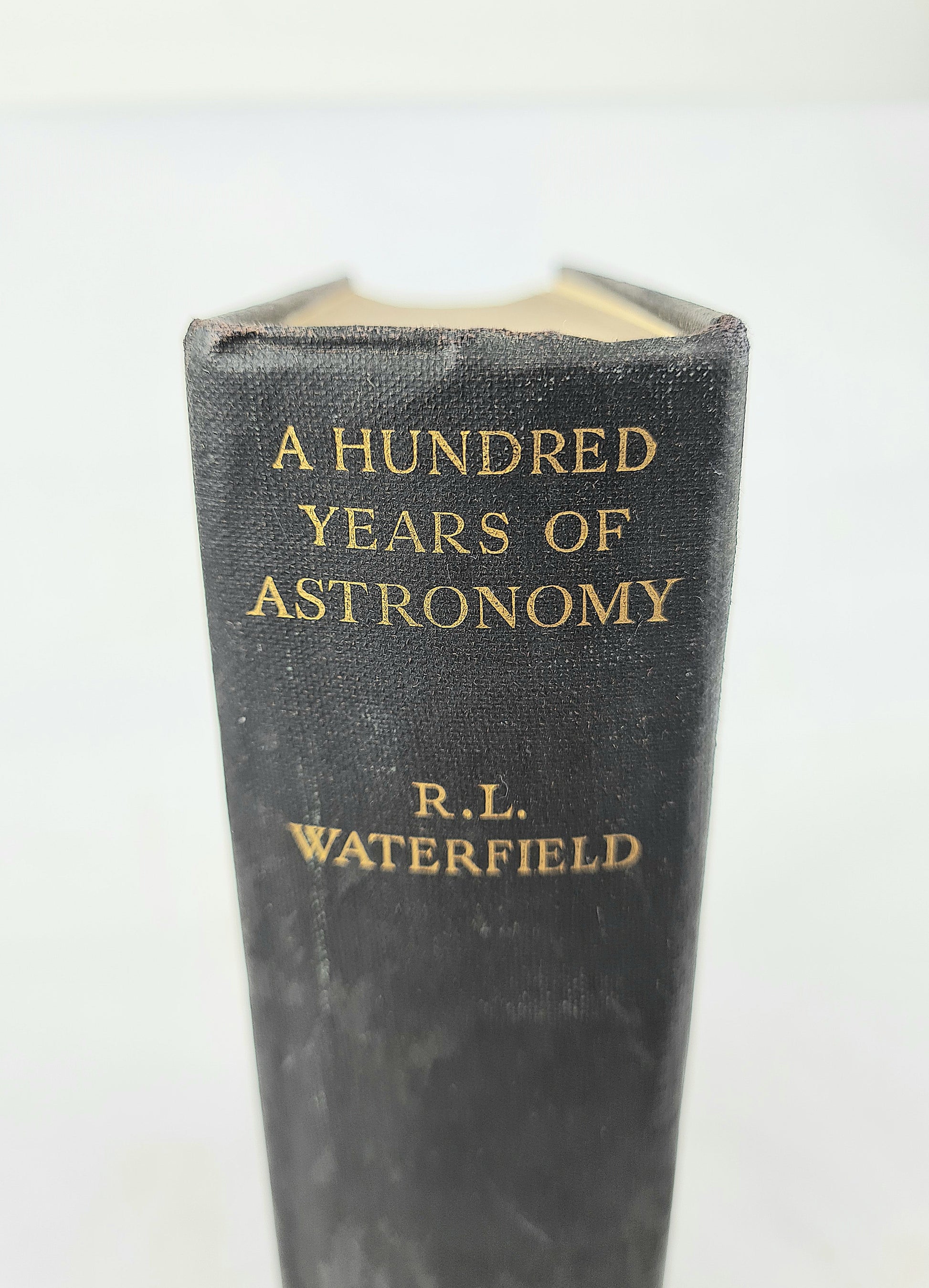 Black antique book with gold lettering 