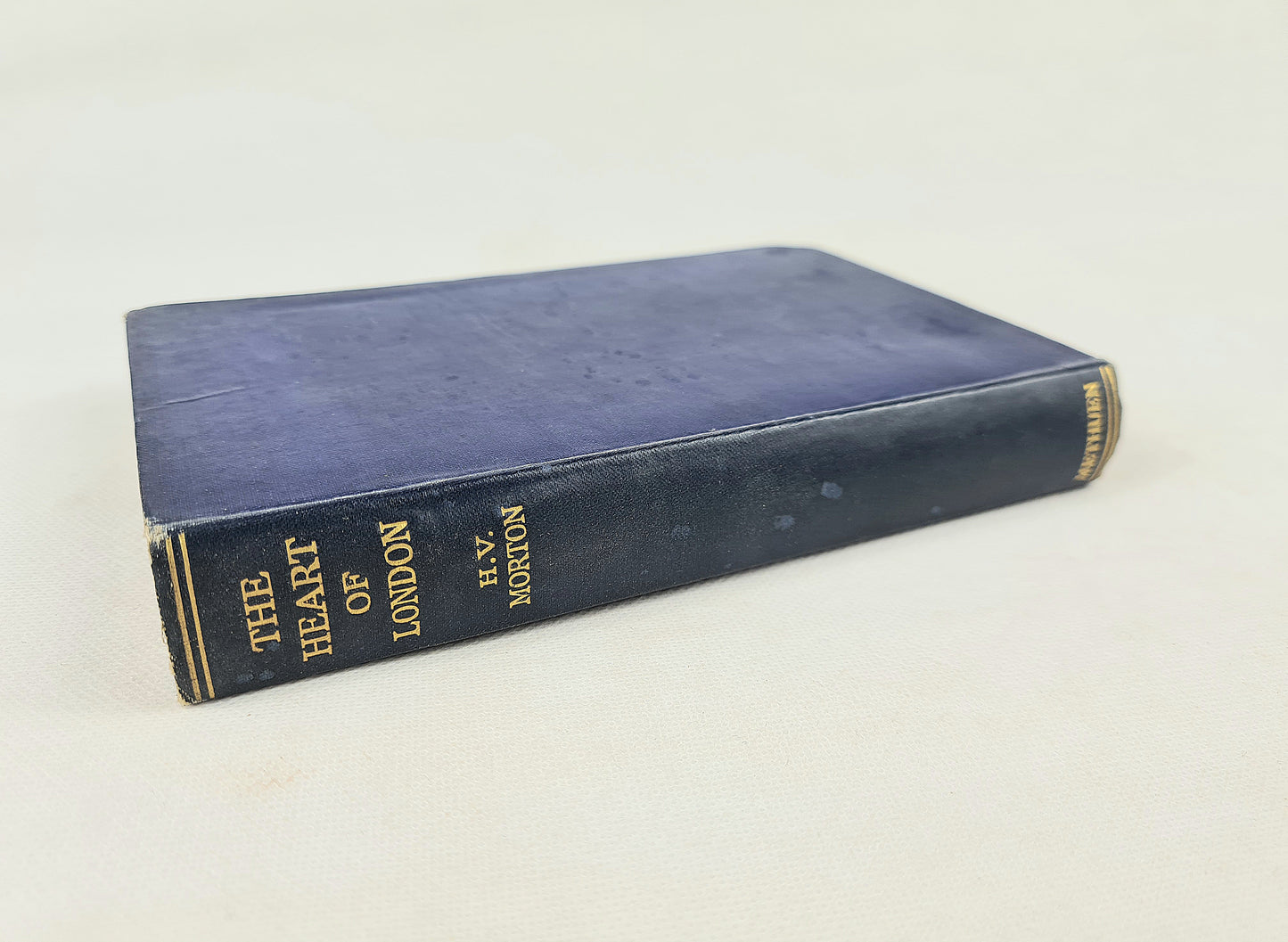 Blue book titled 'The Heart of London' by H.V. Morton on a white background