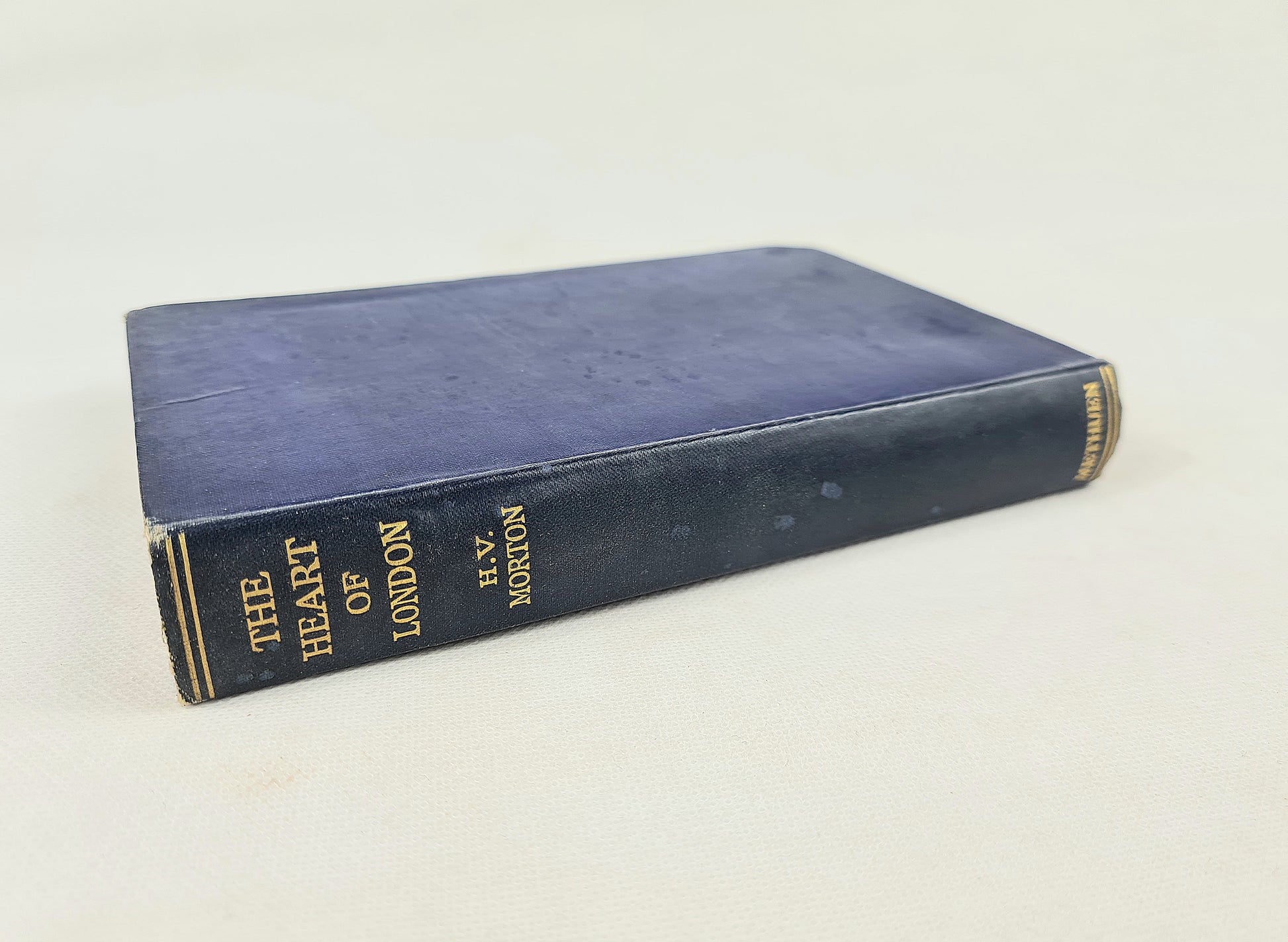Blue book titled 'The Heart of London' by H.V. Morton on a white background