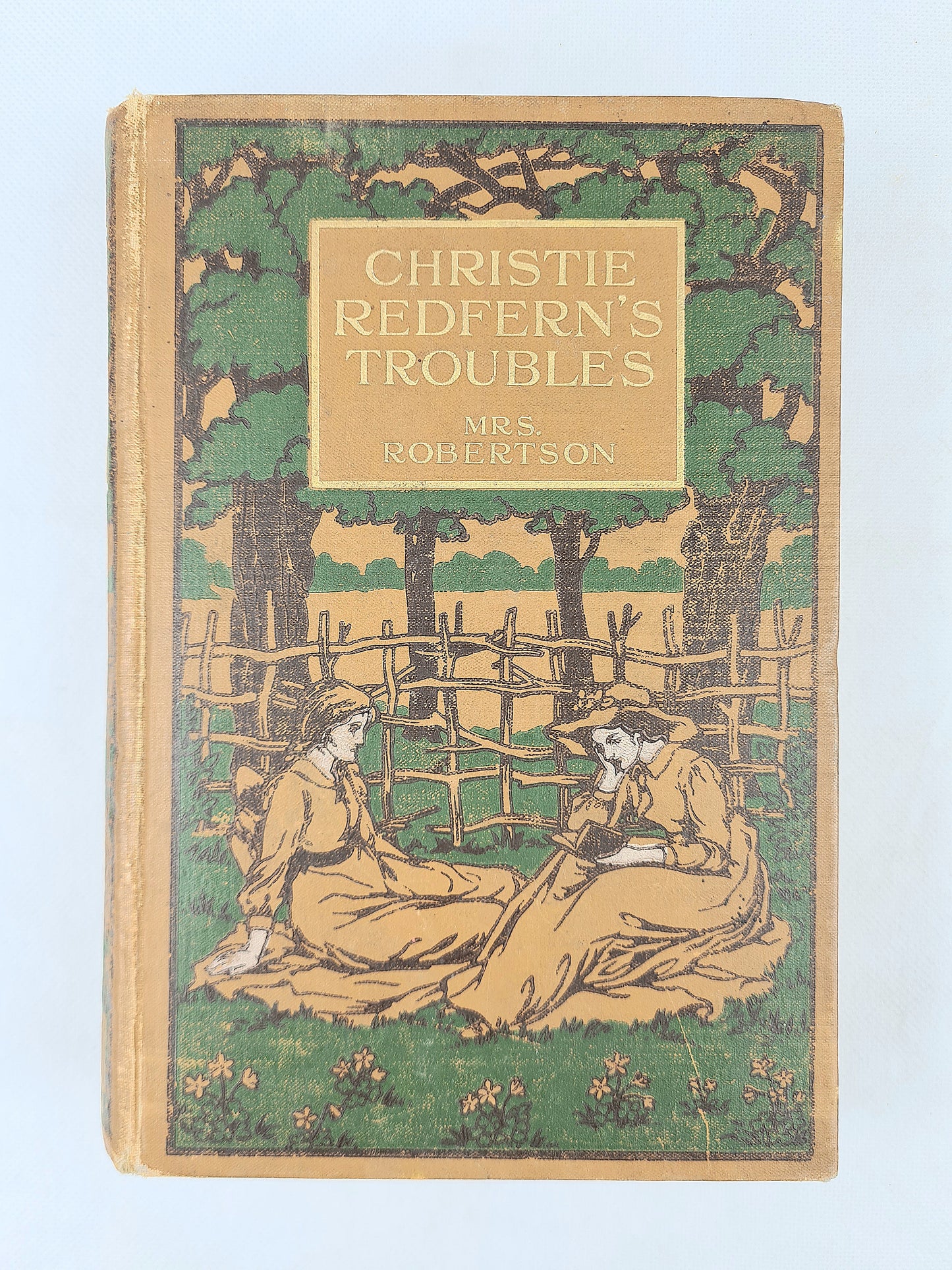 Book cover of 'Christie Redfern's Troubles' with a illustration of two people sitting under a tree.