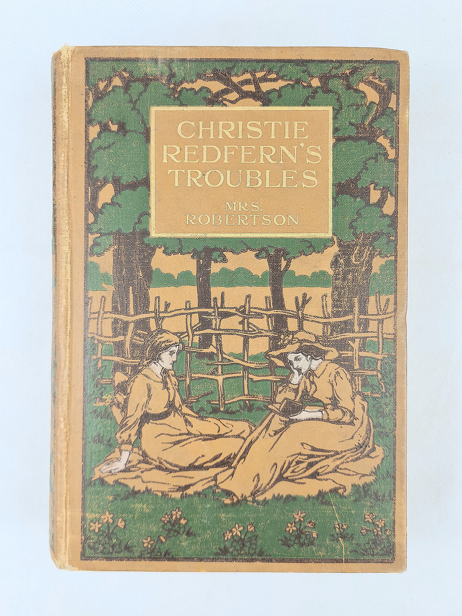 Book cover of 'Christie Redfern's Troubles' with a illustration of two people sitting under a tree.