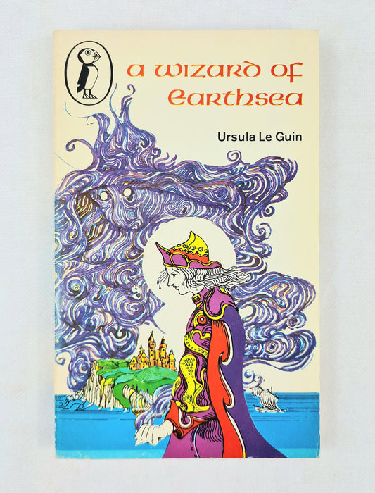 Book cover of 'A Wizard of Earthsea' by Ursula Le Guin with a colorful illustration of a wizard and landscape.