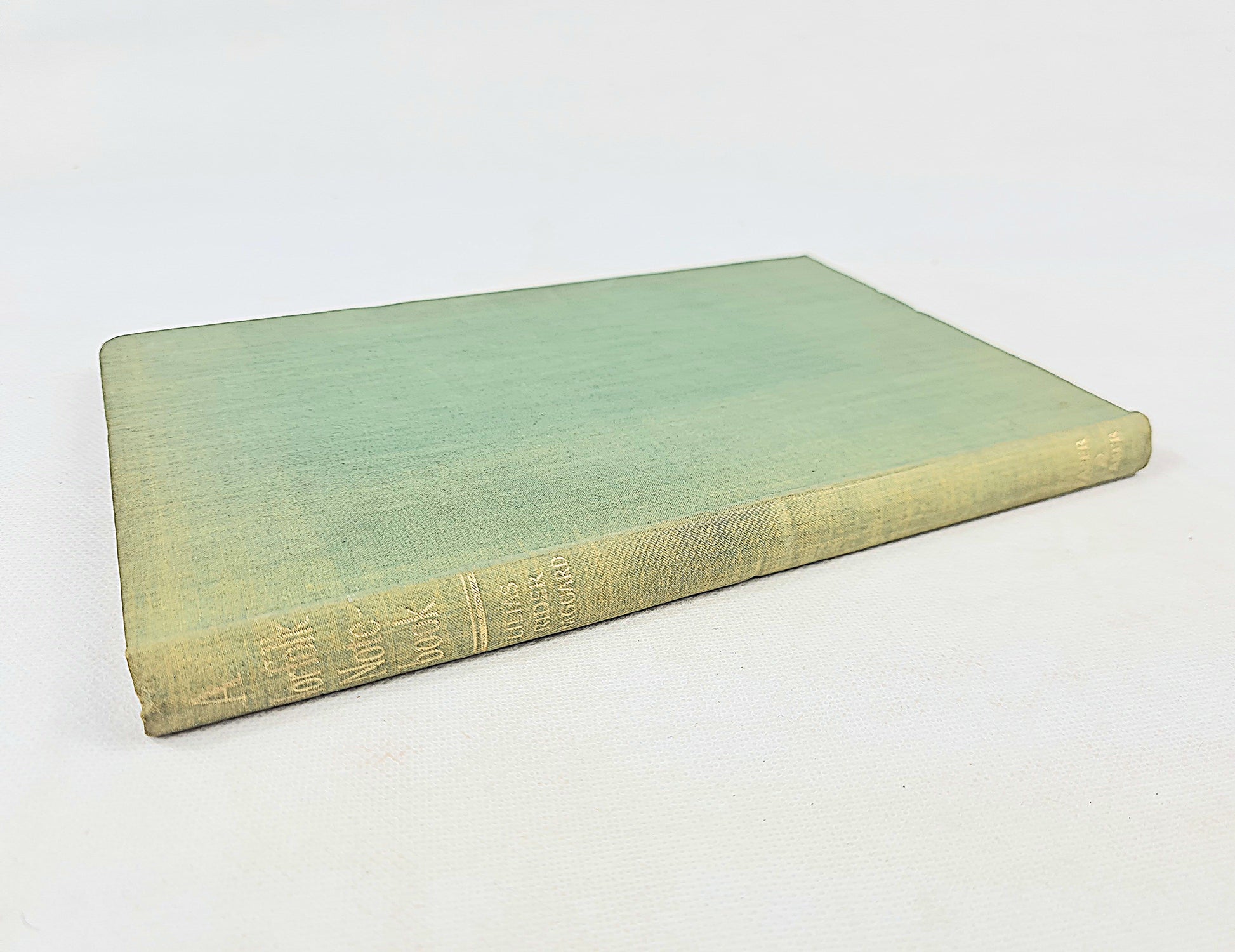 Green book with textured cover on a white background