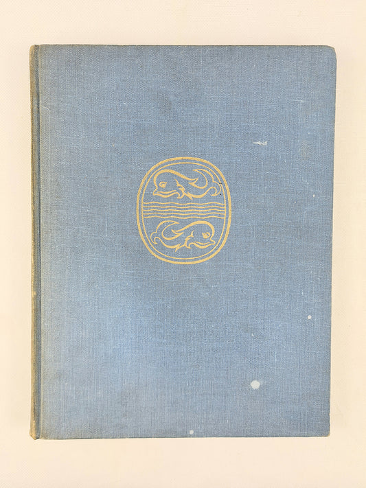 Blue book cover with a gold emblem on a beige background