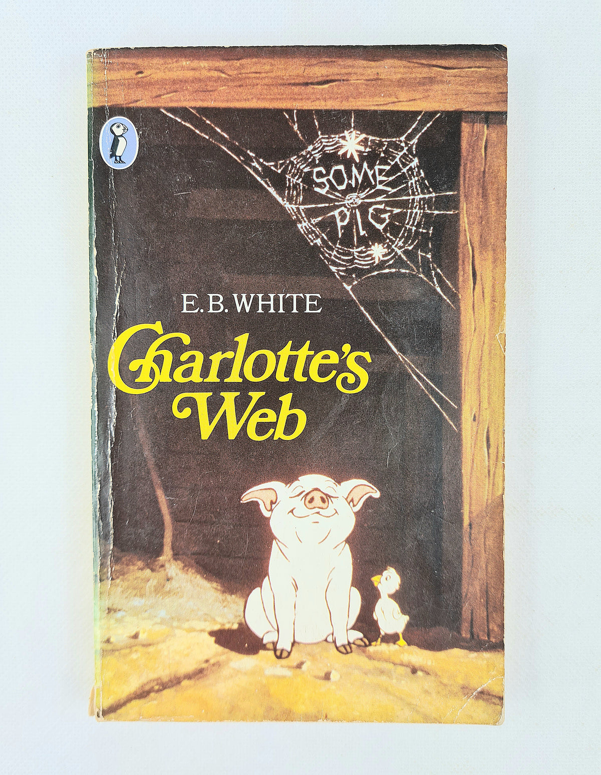 Book cover of 'Charlotte's Web' by E.B. White with a spider web and characters on the cover.