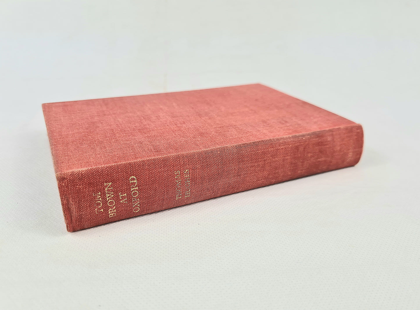 Red book with gold text on white background