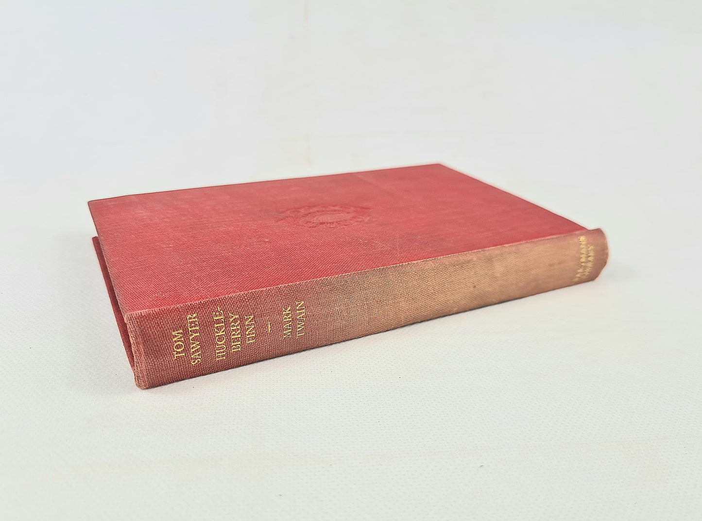 Red book with gold text on a white background