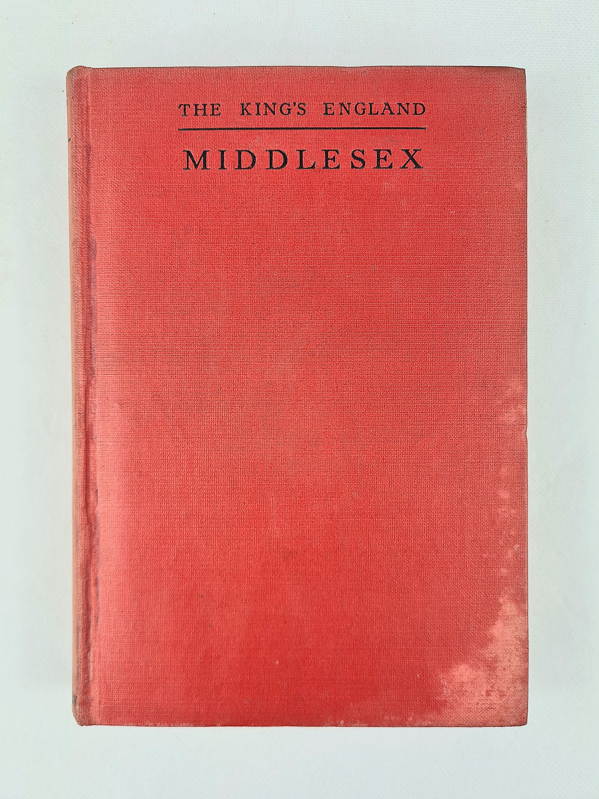 Vintage hardcover book titled 'The King's England Middlesex' with a textured red cover and black lettering, photographed flat against a light background.