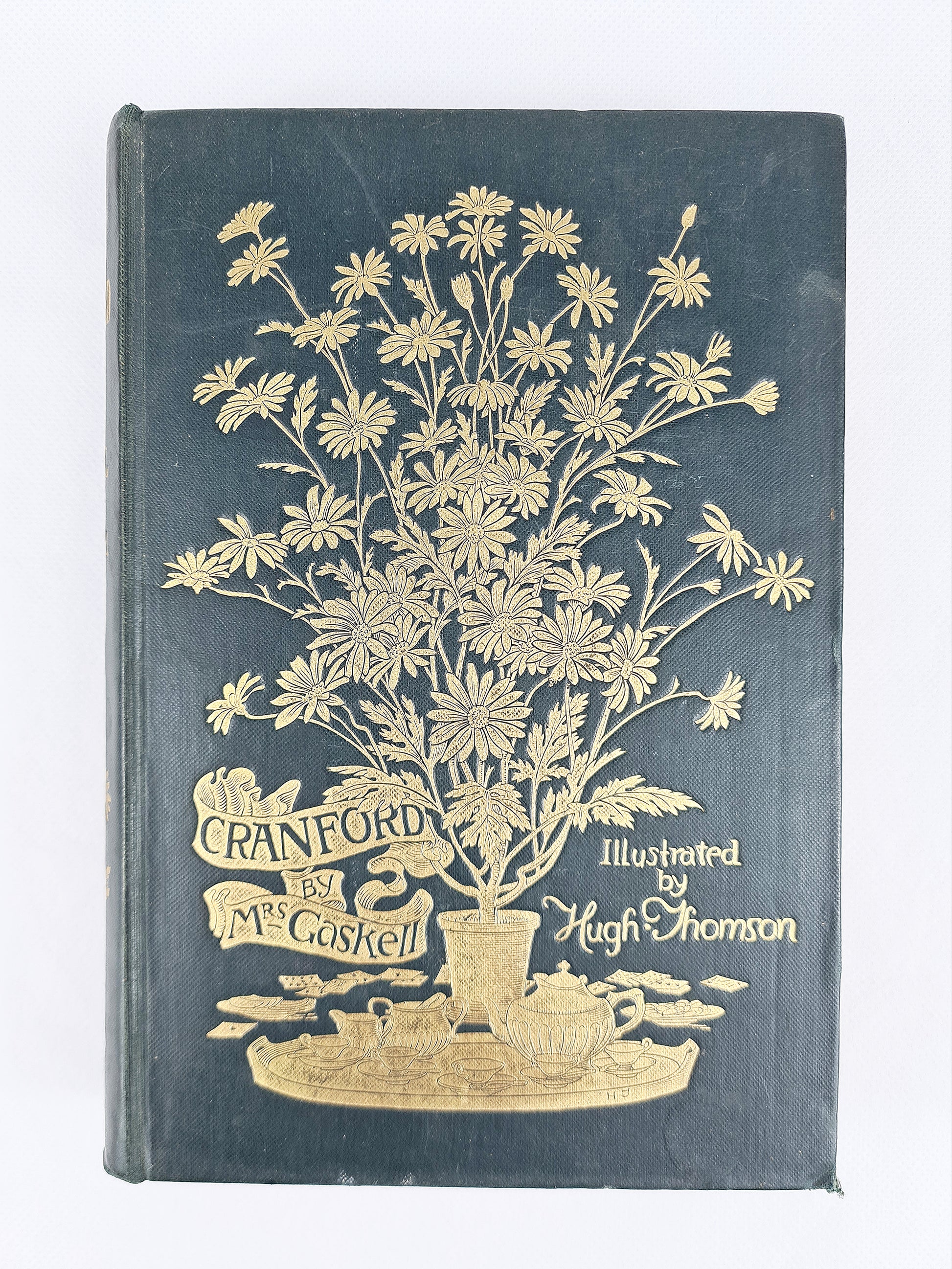 Antique edition of Cranford by Elizabeth Gaskell. A green antique book with gilt decoration 